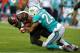 TAMPA, FL - AUGUST 16: Running back Doug Martin #22 of the Tampa Bay Buccaneers is tackled by Cornerback Cortland Finnegan #24 of the Miami Dolphins in the first half at Raymond James Stadium on August 16, 2014 in Tampa, Florida. (Photo by Cliff McBrid