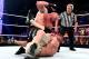 Brock Lesnar pounds on John Cena.