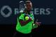 TORONTO, ON - AUGUST 10: Jo-Wilfried Tsonga of France returns a shot to Roger Federer of Switzerland in their finals match during Rogers Cup at Rexall Centre at York University on August 10, 2014 in Toronto, Canada. (Photo by Ronald Martinez/Getty Image