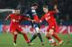PARIS, FRANCE - MARCH 12: Adrien Rabiot of Paris Saint-Germain (C) battles with Omer Toprak (L) and Philipp Wollscheid of Bayer Leverkusen (R) during the UEFA Champions League Round of 16 second leg match between Paris Saint-Germain FC and Bayer Leverkus