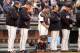 SAN FRANCISCO, CA - AUGUST 12: (L-R) Members of the San Francisco Giants pitching coach Dave Righetti, manager Bruce Bochy, Buster Posey #28, bench coach Ron Wotus, and Javier Lopez #49 stand for a moment of silence for the death of actor Robin Williams