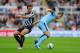 NEWCASTLE UPON TYNE, ENGLAND - AUGUST 17: Edin Dzeko of Man City (r) is challenged by Daryl Janmaat during the Barclays Premier League match between Newcastle United and Manchester City at St James' Park on August 17, 2014 in Newcastle upon Tyne, England