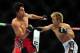 Jun 14, 2014; Vancouver, British Columbia, Canada; Roland Delorme (red) hits Michinoro Tanaka (blue) fduring their Bantamweight bout during UFC 174 at Rogers Arena. Mandatory Credit: Anne-Marie Sorvin-USA TODAY Sports