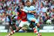 LONDON, ENGLAND - AUGUST 10: Yaya Sanogo of Arsenal challenges Matija Nastasic of Manchester City during the FA Community Shield match between Manchester City and Arsenal at Wembley Stadium on August 10, 2014 in London, England. (Photo by David Rogers/Ge