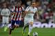 MADRID, SPAIN - AUGUST 19: Luka Modric (R) of Real Madrid CF competes for the ball ahead Koke of Atletico de Madrid (L) during the Supercopa first leg match between Real Madrid and Club Atletico de Madrid at Estadio Santiago Bernabeu on August 19, 2014 in