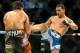 Jul 5, 2014; Las Vegas, NV, USA; Chris Weidman (red gloves ) lands a kick to Lyoto Machida (blue gloves) during a middleweight title fight at Mandalay Bay Events Center. Mandatory Credit: Stephen R. Sylvanie-USA TODAY Sports