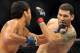 Jul 5, 2014; Las Vegas, NV, USA; Lyoto Machida (blue gloves) lands a blow to Chris Weidman (red gloves) during a middleweight title fight at Mandalay Bay Events Center. Mandatory Credit: Stephen R. Sylvanie-USA TODAY Sports