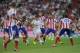 MADRID, SPAIN - AUGUST 19: Angel di Maria of Real Madrid is surrounded by Club Atletico de Madrid players during the Supercopa first leg match between Real Madrid and Club Atletico de Madrid at Estadio Santiago Bernabeu on August 19, 2014 in Madrid,