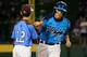 SOUTH WILLIAMSPORT, PA - AUGUST 20: Brennan Holligan #27 of Nevada is congratulated by shortstop Jared Sprague-Lott of Pennsylvania after hitting a two RBI home run during the sixth inning of the United States division game at the Little League World Se