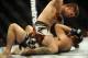Feb 22, 2014; Las Vegas, NV, USA; Mike Pyle (red gloves) pins TJ Waldburger (blue gloves) to the mat and throws an elbow to his face during their UFC welterweight bout at Mandalay Bay. Pyle won the bout by way of TKO in the third round. Mandatory Credit: