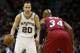 Jun 5, 2014; San Antonio, TX, USA; San Antonio Spurs guard Manu Ginobili (20) handles the ball aianst Miami Heat guard Ray Allen (34) during the first quarter in game one of the 2014 NBA Finals at AT&T Center. Mandatory Credit: Soobum Im-USA TODAY Sports