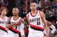 PORTLAND, OR - JANUARY 28: Damian Lillard #0 and Nicolas Batum #88 of the Portland Trail Blazers walk off the court against the Memphis Grizzlies on January 28, 2014 at the Moda Center Arena in Portland, Oregon. NOTE TO USER: User expressly acknowledges