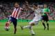 MADRID, SPAIN - AUGUST 19: Angel di Maria (R) of Real Madrid shoots past Raul Garcia of Club Atletico de Madrid during the Supercopa first leg match between Real Madrid and Club Atletico de Madrid at Estadio Santiago Bernabeu on August 19, 2014 in Madrid