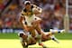 LONDON, ENGLAND - AUGUST 23: Luke Dorn of Castleford is tackled by Liam Sutcliffe (L) and Kevin Sinfield (R) of Leeds during the Tetley's Challenge Cup Final between Leeds Rhinos and Castleford Tigers at Wembley Stadium on August 23, 2014 in London, Engl