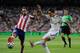 MADRID, SPAIN - AUGUST 19: Angel di Maria (R) of Real Madrid shoots past Raul Garcia of Club Atletico de Madrid during the Supercopa first leg match between Real Madrid and Club Atletico de Madrid at Estadio Santiago Bernabeu on August 19, 2014 in Madrid