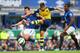 LIVERPOOL, ENGLAND - AUGUST 23: Olivier Giroud of Arsenal shoots at goal under pressure from Leighton Baines and Sylvain Distin of Everton during the Barclays Premier League match between Everton and Arsenal at Goodison Park on August 23, 2014 in Liverp