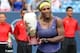 Aug 17, 2014; Cincinnati, OH, USA; Serena Williams holds up the trophy after defeating Ana Ivanovic (not pictured) on day seven of the Western and Southern Open tennis tournament at Linder Family Tennis Center. Mandatory Credit: Mark Zerof-USA TODAY Sport
