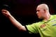 LONDON, ENGLAND - JANUARY 1: Michael van Gerwen of the Netherlands in action against Phil Taylor of England during the final of the 2013 Ladbrokes.com World Darts Championship at the Alexandra Palace on January 1, 2013 in London, England. (Photo by Ben Ho