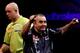 LONDON, ENGLAND - JANUARY 1: Phil Taylor celebrates winning the tenth set as Michael van Gerwen of the Netherlands looks on during the final of the 2013 Ladbrokes.com World Darts Championship at the Alexandra Palace on January 1, 2013 in London, England.