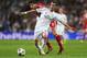 MADRID, SPAIN - APRIL 23: Angel Di Maria of Real Madrid is challenged by Javi Martinez of Bayern Muenchen during the UEFA Champions League semi-final first leg match between Real Madrid and FC Bayern Muenchen at the Estadio Santiago Bernabeu on April 23,