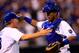 KANSAS CITY, MO - AUGUST 08: Salvador Perez #13 of the Kansas City Royals is congratulated by manager Ned Yost #3 as the Royals defeat the San Francisco Giants 4-2 to win the game at Kauffman Stadium on August 8, 2014 in Kansas City, Missouri. (Photo b