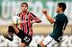 GOIANIA, BRAZIL - JULY 27: Douglas (L) of Sao Paulo struggles for the ball with a Welinton Junior of Goias during a match between Goias and Sao Paulo as part of Brasileirao Series A 2014 at Serra Dourada Stadium on July 27, 2014 in Goiania, Brazil. (Photo