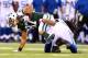 EAST RUTHERFORD, NJ - AUGUST 07: Wide receiver Eric Decker #87 of the New York Jets is tackled by defensive back Josh Gordy #27 of the Indianapolis Colts in the first quarter during a preseason game at MetLife Stadium on August 7, 2014 in East Rutherford,