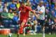 PRESTON, LANCASHIRE - JULY 19: Keith Keane of Preston in action with Fabio Borini of Liverpool during the pre season friendly match between Preston North End and Liverpool at Deepdale on July 19, 2014 in Preston, Lancashire. (Photo by Michael Regan/Gett