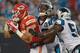 CHARLOTTE, NC - AUGUST 17: Travis Kelce #87 of the Kansas City Chiefs drags Robert Lester #38 and Jason Williams #54 of the Carolina Panthers into the end zone for a touchdown during their game at Bank of America Stadium on August 17, 2014 in Charlotte,