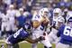 INDIANAPOLIS, IN - AUGUST 16: Chandler Harnish #5 of the Indianapolis Colts gets sacked by Damontre Moore #98 of the New York Giants in the second half of an NFL preseason game at Lucas Oil Stadium on August 16, 2014 in Indianapolis, Indiana. (Photo by Jo