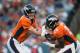 DENVER, CO - AUGUST 23: Quarterback Peyton Manning #18 of the Denver Broncos hands off to Montee Ball #28 against the Houston Texans during a preseason game at Sports Authority Field at Mile High on August 23, 2014 in Denver, Colorado. (Photo by Dustin
