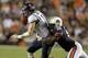 Oct 5, 2013; Auburn, AL, USA; Mississippi Rebels quarterback Bo Wallace (14) is tackled by Auburn Tigers defensive end Carl Lawson (55) during the first half at Jordan Hare Stadium. Mandatory Credit: John Reed-USA TODAY Sports