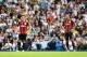 LONDON, ENGLAND - AUGUST 24: Joey Barton (L) and Rio Ferdinand of QPR look dejected after the third Spurs goal during the Barclays Premier League match between Tottenham Hotspur and Queens Park Rangers at White Hart Lane on August 24, 2014 in London, Engl