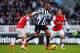 NEWCASTLE UPON TYNE, ENGLAND - DECEMBER 29: Loic Remy of Newcastle United is closed down by Jack Wilshere (L) and Tomas Rosicky of Arsenal during the Barclays Premier League match between Newcastle United and Arsenal at St James' Park on December 29, 201