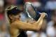 NEW YORK, NY - AUGUST 25: Maria Sharapova of Russia returns a shot against Maria Kirilenko of Russia during her women's singles first round match on Day One of the 2014 US Open at the USTA Billie Jean King National Tennis Center on August 25, 2014 in th