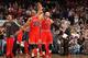 Gibson high-fives former Bulls forward Carlos Boozer.