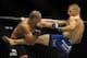 May 24, 2014; Las Vegas, NV, USA; TJ Dillashaw (blue) lands a kick on Renan Barao (red) during their UFC 173 bantamweight championship bout at MGM Grand Garden Arena. Dillashaw won the bout by way of TKO. Mandatory Credit: Stephen R. Sylvanie-USA TODAY