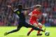 LIVERPOOL, ENGLAND - AUGUST 17: Joe Allen of Liverpool is tackled by Victor Wanyama of Southampton during the Barclays Premier League match between Liverpool and Southampton at Anfield on August 17, 2014 in Liverpool, England. (Photo by Alex Livesey/Gett