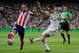 MADRID, SPAIN - AUGUST 19: Angel di Maria (R) of Real Madrid shoots past Raul Garcia of Club Atletico de Madrid during the Supercopa first leg match between Real Madrid and Club Atletico de Madrid at Estadio Santiago Bernabeu on August 19, 2014 in Madrid