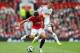 MANCHESTER, ENGLAND - AUGUST 16: Javier Hernandez of Manchester United competes with Gylfi Sigurdsson of Swansea City during the Barclays Premier League match between Manchester United and Swansea City at Old Trafford on August 16, 2014 in Manchester, En