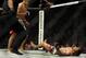 May 24, 2014; Las Vegas, NV, USA; Tony Ferguson (red) watches Katsunori Kikuno (blue) fall to the mat after landing a TKO punch during their UFC 173 welterweight bout at MGM Grand Garden Arena. Ferguson won the bout by TKO. Mandatory Credit: Stephen R. Sy