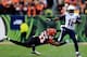 CINCINNATI, OH - JANUARY 05: Wide receiver Eddie Royal #11 of the San Diego Chargers runs with the ball as defensive end Michael Johnson #93 of the Cincinnati Bengals defends during a Wild Card Playoff game at Paul Brown Stadium on January 5, 2014 in Cin