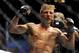 May 24, 2014; Las Vegas, NV, USA; TJ Dillashaw (blue) celebrates after a successful third round against opponent Renan Barao (not pictured) during their UFC 173 bantamweight championship bout at MGM Grand Garden Arena. Dillashaw won the bout by way of TK