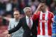 STOKE ON TRENT, ENGLAND - APRIL 26: Stoke City manager Mark Hughes shows his frustrations as he speaks to his player Geoff Cameron during the Barclays Premier League match between Stoke City and Tottenham Hotspur at the Britannia Stadium on April 26, 201
