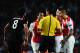 LONDON, ENGLAND - AUGUST 27: Mathieu Debuchy (R) of Arsenal is sent off by match referee Pedro Proenca during the UEFA Champions League Qualifier 2nd leg match between Arsenal and Besiktas at the Emirates Stadium on August 27, 2014 in London, United King