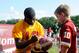 ASHBURN, VA - JULY 26: Robert Griffin III #10 of the Washington Redskins signs an autograph for a fan as he walks off the field during training camp at Redskins Park on July 26, 2012 in Ashburn, Virginia. (Photo by Patrick McDermott/Getty Images)
