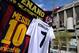 MADRID, SPAIN - MARCH 23: Shirts bearing the names of Lionel Messi of FC Barcelona and Cristiano Ronaldo of Real Madrid CF are see at a merchandise stall prior to the La Liga match between Real Madrid CF and FC Barcelona at estadio Santiago Bernabeu on M