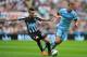NEWCASTLE UPON TYNE, ENGLAND - AUGUST 17: Newcastle player Remy Cabella (l) challenges Edin Dzeko of Man City during the Barclays Premier League match between Newcastle United and Manchester City at St James' Park on August 17, 2014 in Newcastle upon Tyn