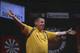 DUBAI, UNITED ARAB EMIRATES - MAY 29: Dave Chisnall of England celebrates after defeating Simon Whitlock of Australia during the 2014 Dubai Duty Free Darts Masters Quarter-Final match at Dubai Duty Free Tennis Stadium, Irish Village on May 29, 2014 in Du