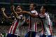 MADRID, SPAIN - AUGUST 19: Raul Garcia (L) of Atletico de Madrid celebrates scoring the opening goal with teammates Diego Godin (2nd R) and Raul Jimenez (R) during the Supercopa first leg match between Real Madrid and Club Atletico de Madrid at Estadio S